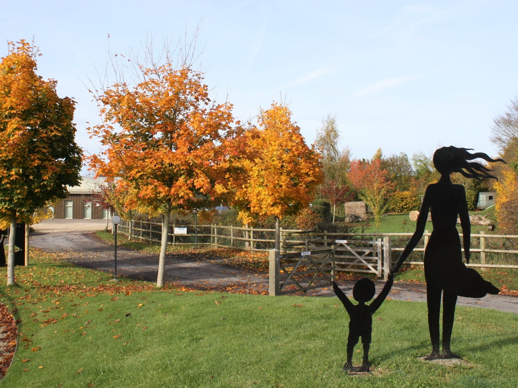 A picture of a sculpture at Learning Curve Day Nursery showing a mother and her child
