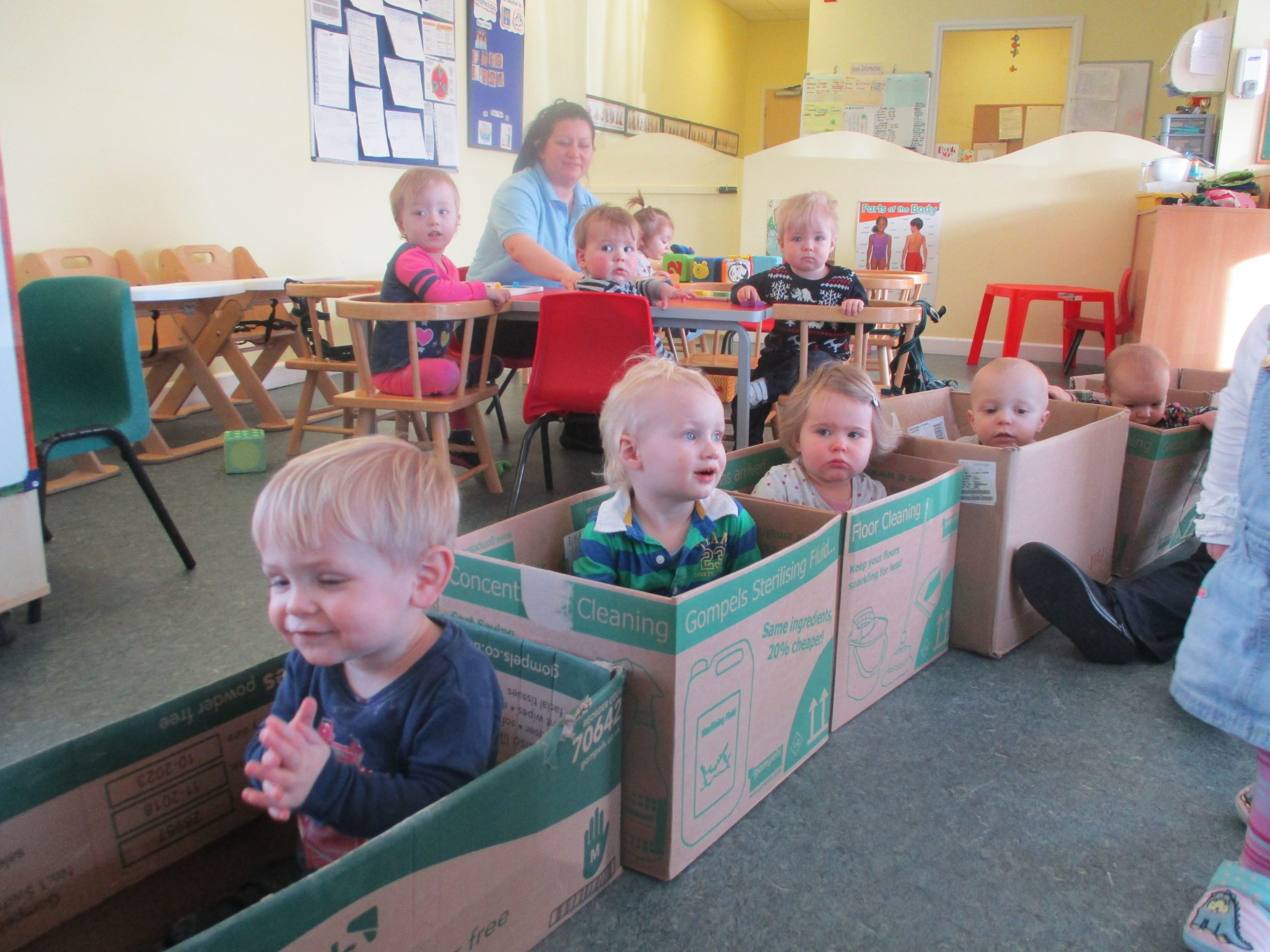 A picture of children playing in cardboard boxes.
